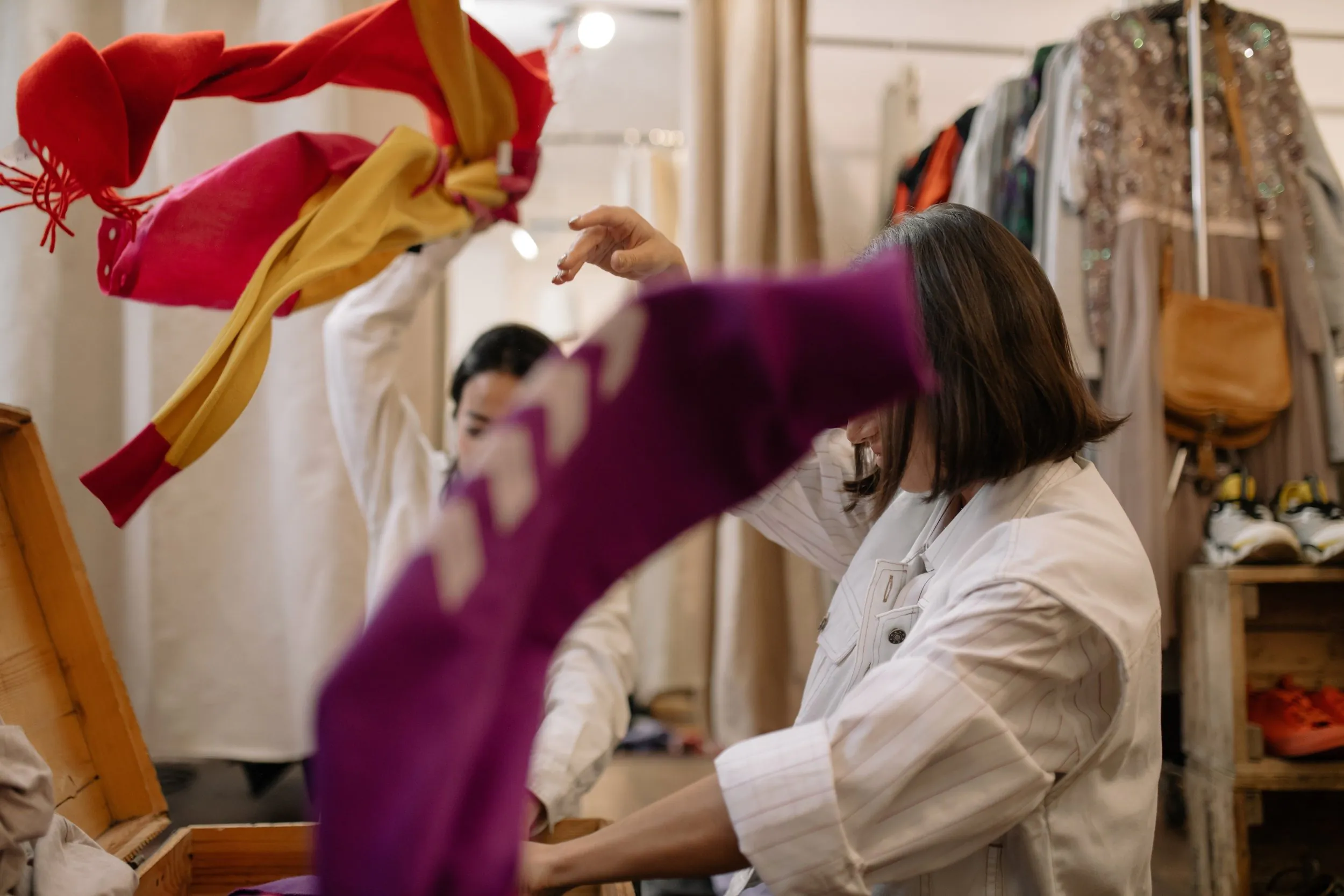 women looking at clothes on a rack