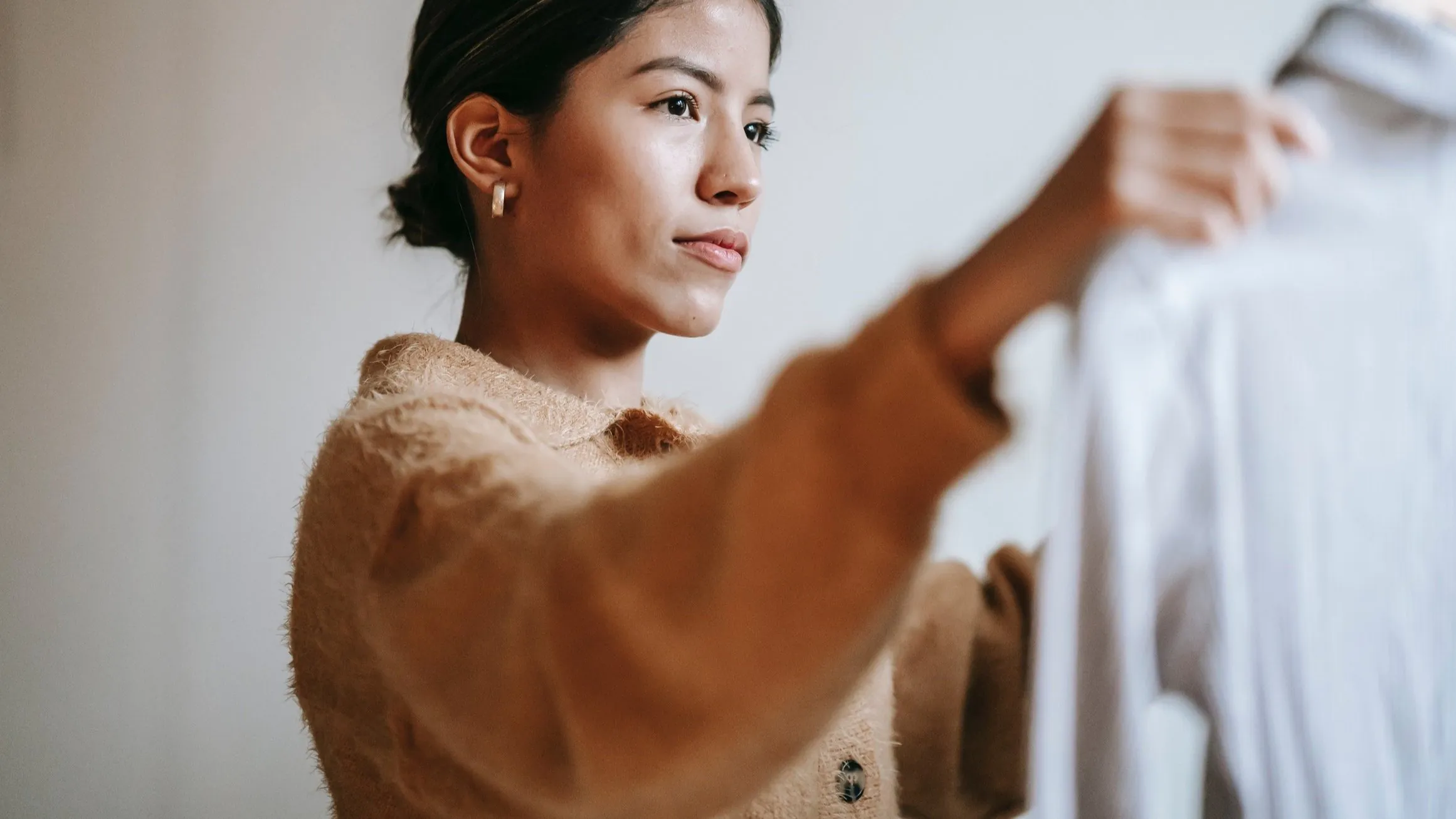 women looking at a shirt on a hanger